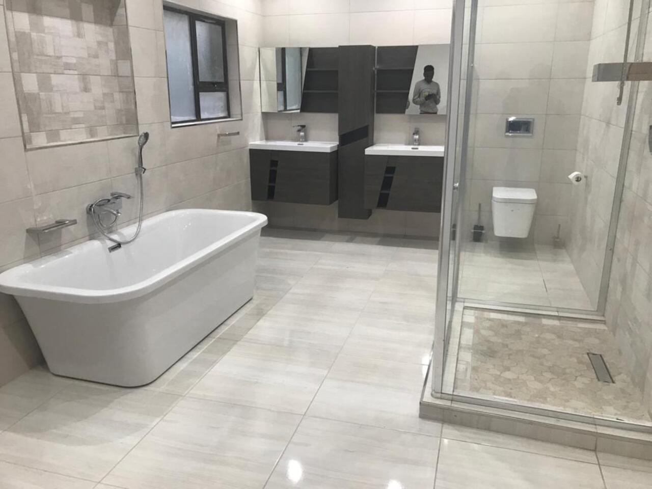 Modern shower plumbing and glass enclosure installation