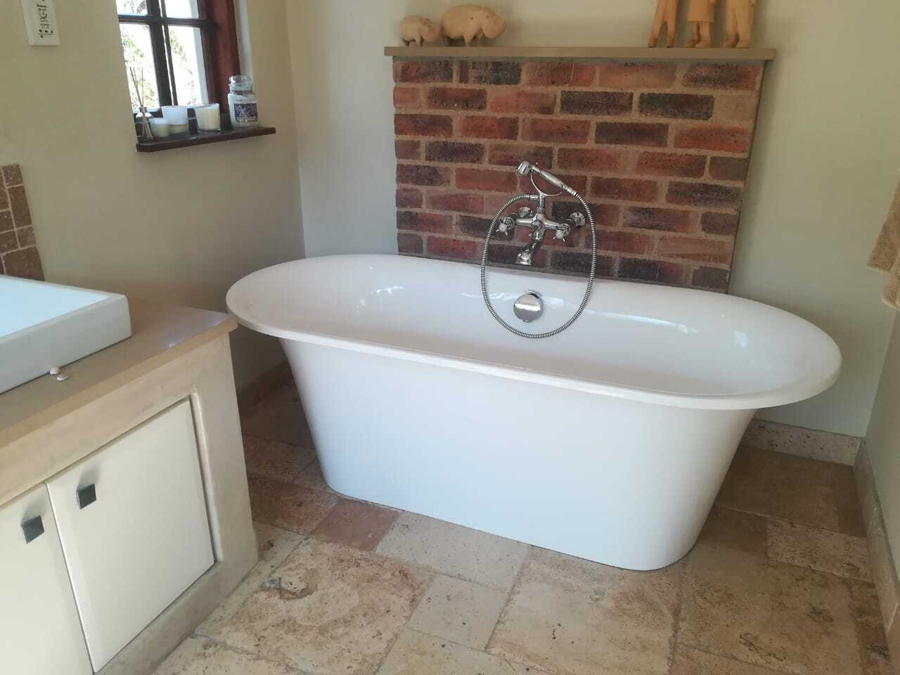 Freestanding bathtub and chrome mixer installation