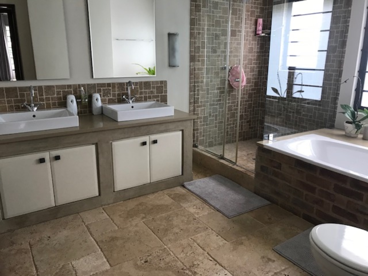 Master ensuite bathroom with double vanity, walk-in shower and tub